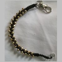 Black bracelet with gold beads